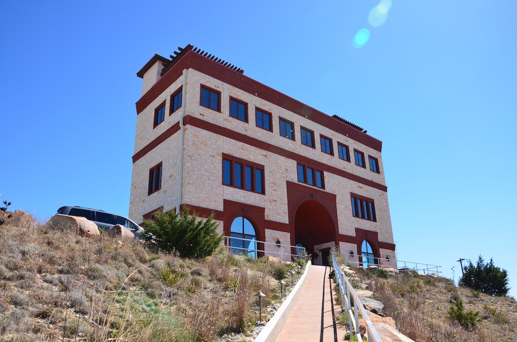 View from the parking lot. Wine tasting on the ground floor and top deck with vacation suite rentals on the second and third floors. The third floor is one unit!
