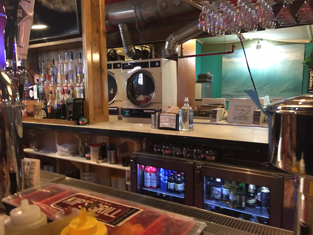 Laundromat behind the bar.