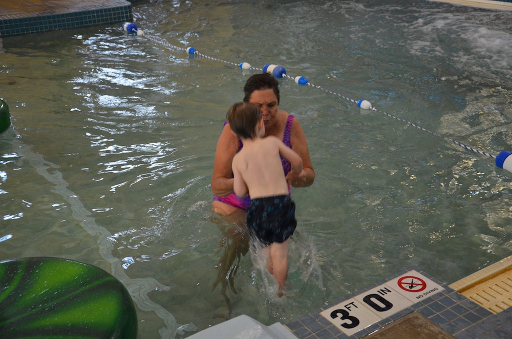 Jan teaching Reeve water safety; how to swim to the side to get out after jumping in. He had a blast!